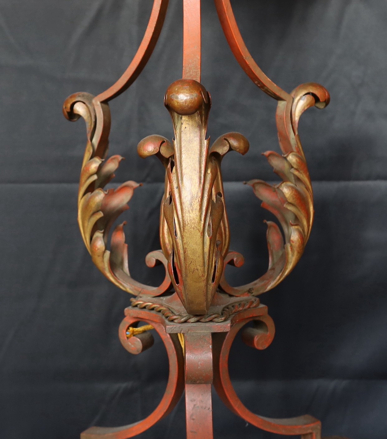 A 1950s Italian parcel gilt red painted wrought iron and tole ware lamp standard with smoked crackle glass shade, height 163cm. diameter 52cm.
